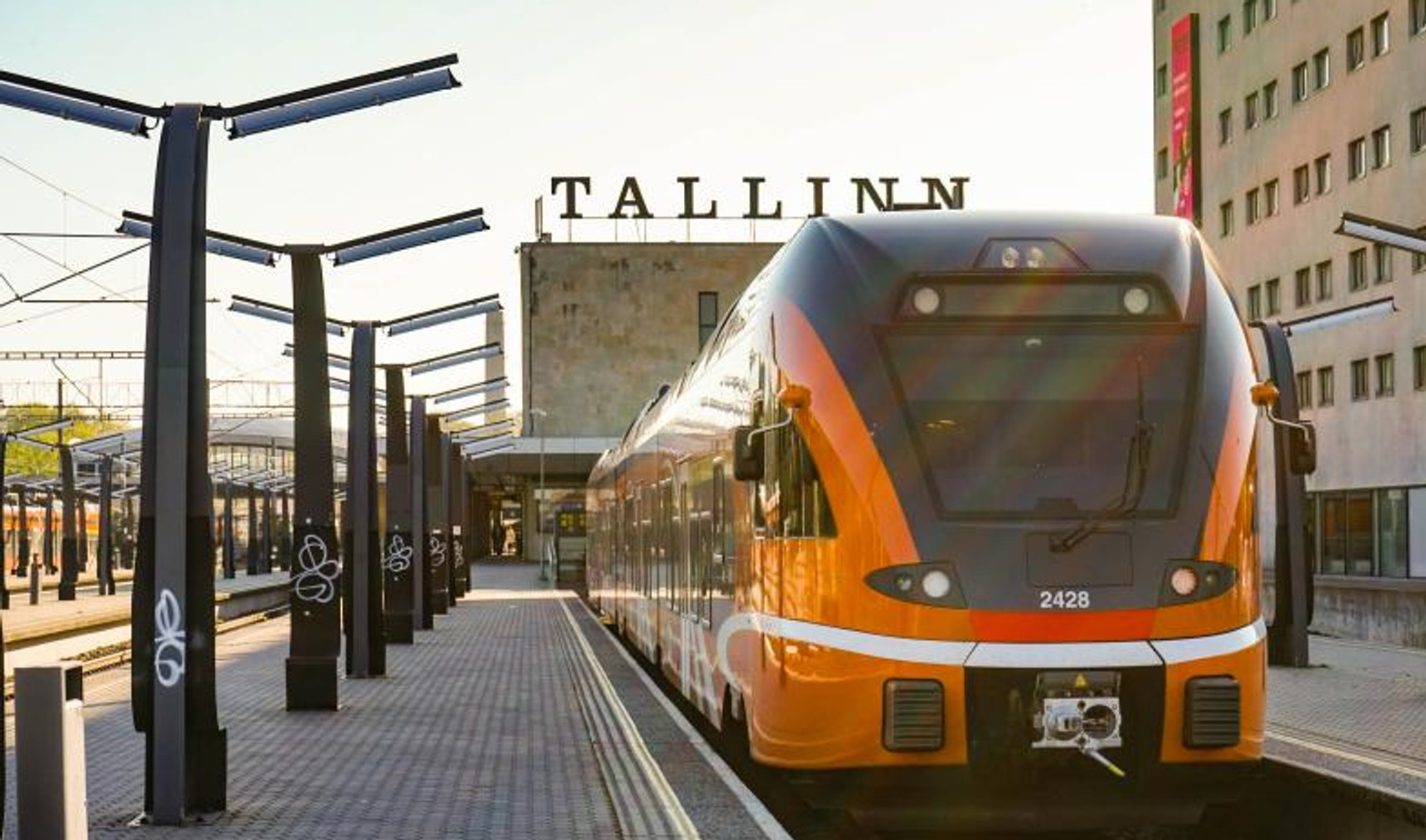 An orange Elron train at Tallinn Baltic Station